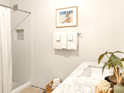 Refresh in your bright, spa-like bathroom with marble counters and modern shower.