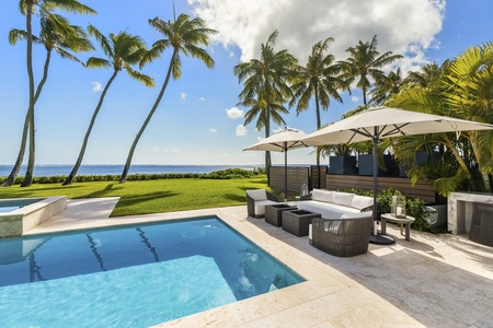 Outdoor dining area by the pool, where guests can share festive meals steps from the ocean.
