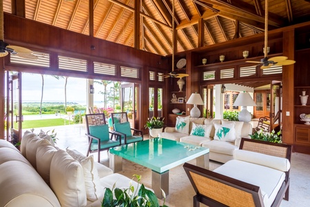 Relax in the living area with high, vaulted ceilings and seamless access to the garden.