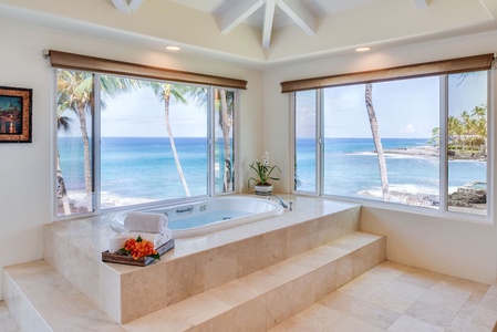 Indulge in relaxation in the Lihikai Master ensuite soaking tub, as expansive windows frame breathtaking ocean views