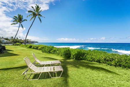 Relax on the outdoor chaise loungers by the beach.