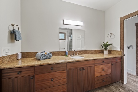 Spacious vanity with ample storage and minimalist lighting—function meets form.