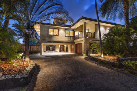 Evening exterior with full glow-up—luxury lighting welcomes you home after sunset adventures.