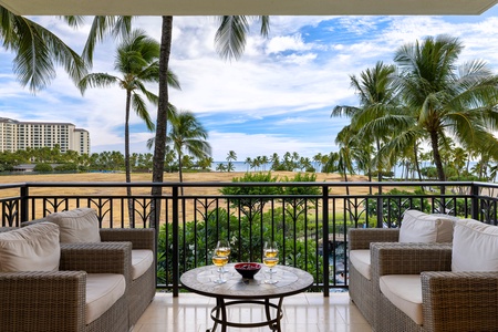 Unwind at sunset on the lanai, surrounded by palm trees and breathtaking ocean views.