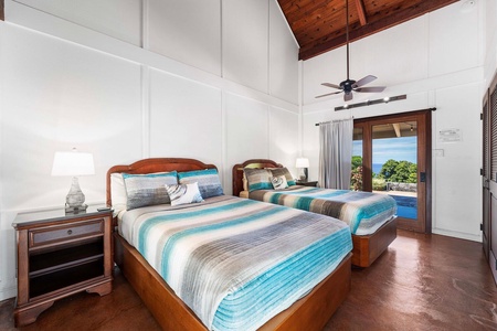Second guest bedroom with two beds and direct pool access.