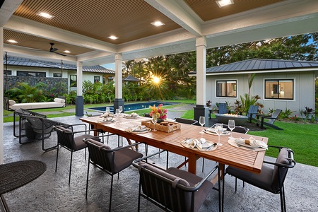 Elegant outdoor dining area overlooking the pool, perfect for evening gatherings.