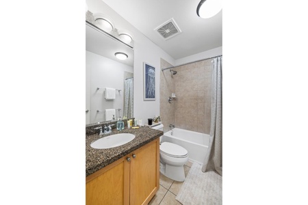 Refresh in the spa-style ensuite showcasing a granite vanity and walk-in shower.