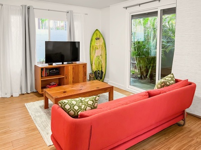 Unwind in the guest cottage living room with a sleeper sofa and garden views.