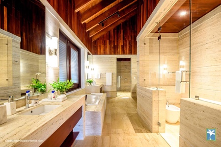 Modern primary ensuite bathroom with elegant design and ample natural light.