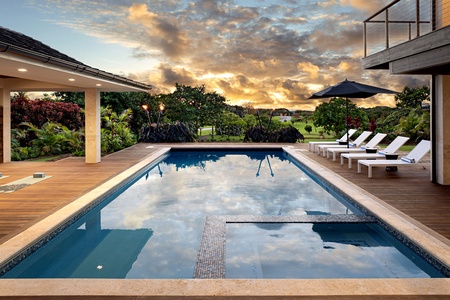 Enjoy a tranquil swim in the sparkling pool surrounded by lush greenery and stunning sunsets.