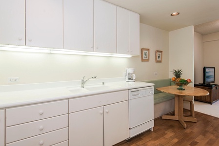 The kitchen has white cabinetry for extra storage.