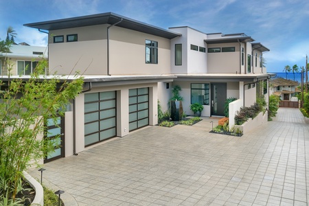 The entryway and two-car garage at Diamond Head Grandeur provide a grand welcome, ensuring both convenience and security for your luxury vacation in Honolulu.