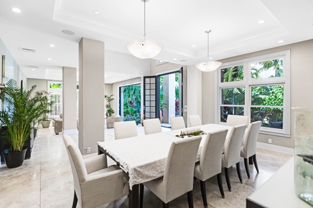 Garden-view dining with natural tones and comfortable seating for ten.