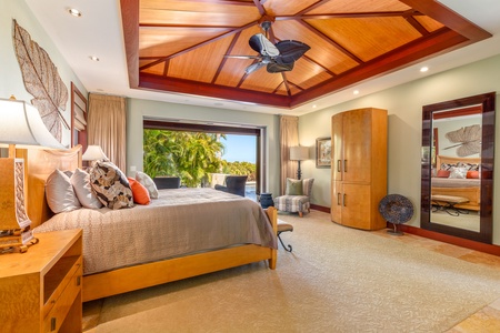 Enjoy restful nights in a spacious primary suite with elegant ceiling details and sliding glass doors to the lanai.