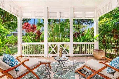 Tranquil lanai retreat surrounded by lush tropical foliage.