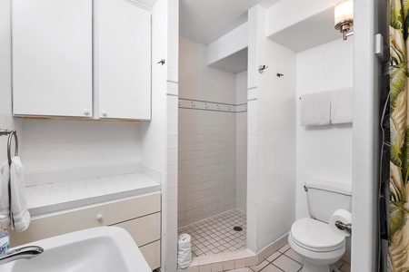 Compact bathroom with storage, washer/dryer, and essentials.