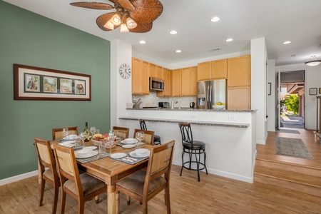 Stylish dining space designed for gathering, featuring warm wood tones and tropical accents.
