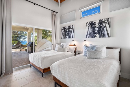 Guest suite comes with two full-sized beds and an accent wall of tropical-inspired art.