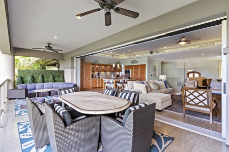 Seamless indoor-outdoor living with a spacious lanai, comfortable dining area, and cozy seating flowing into the open-concept living and kitchen space