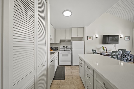 The kitchen offers ample counter spaces for a breezy meal prep.