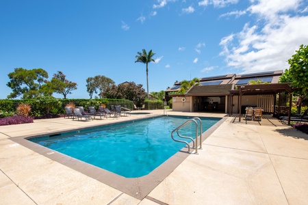 Lounge poolside at Cabana A, featuring a sparkling pool, heated jacuzzi, and plenty of sun-soaked seating to unwind in paradise.