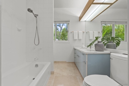 A full bathroom with a deep tub and overhead shower offers comfort and convenience for guests and families alike.