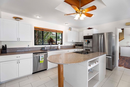 The fully-stocked kitchen has stainless steel appliances and wide counter spaces for easy meal prepping.