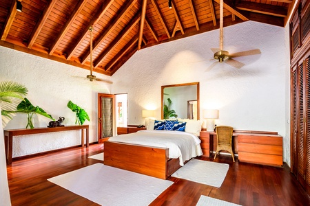 The guest bedroom with high ceilings and stylish decor.