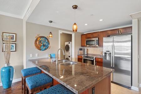 Spacious kitchen opens to the bright living area at Honua Kai Konea 204.