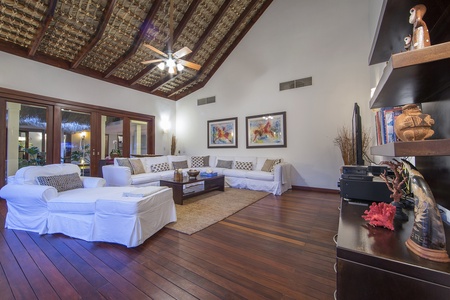 Relax in this spacious living room with high ceilings and comfortable seating.