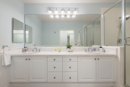 Modern primary ensuite with double vanity, walk-in shower, and spa-like finishes.