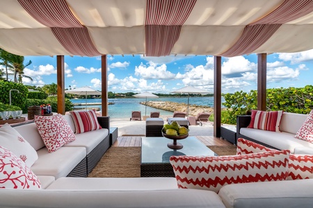 Charming beachfront gazebo, featuring cozy seating and stunning views of the turquoise waters.