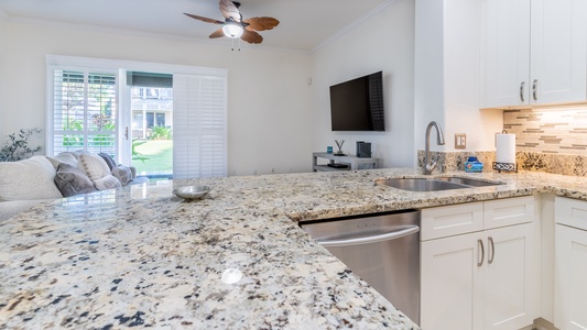 Settle in for a movie night on TV with snacks in the kitchen bar area.