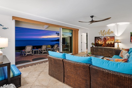 Unwind in a breezy living space, where open doors frame the ocean beyond.