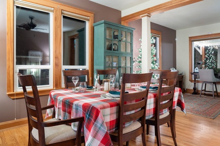 Gather for joyful meals in the festive dining area, filled with light and seasonal charm.