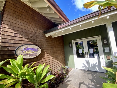 The entrance to Kapalua Ridge Villas Resort’s serene community center is surrounded by vibrant greenery.