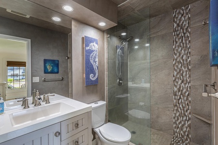 The ensuite bathroom has a single vanity and separate shower.