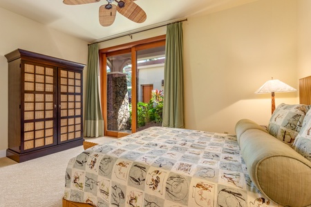 Relax in a cozy guest room with direct access to the garden lanai and refreshing tropical breezes.