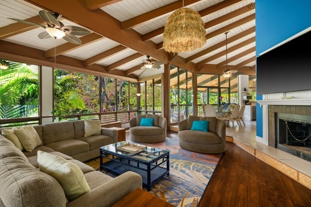 Vaulted wood beams rise over the living room where the group lands after the beach.