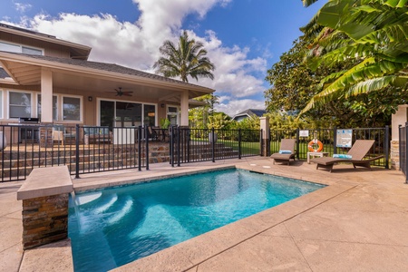 Gated pool area at Pohaku Villa with ample patio space, ideal for safe and relaxing family fun.