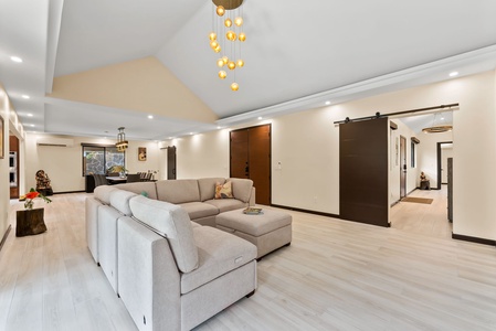 Bright and inviting living room with vaulted ceilings and natural light.