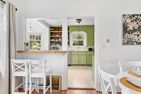 An inviting corner dining setup with modern farmhouse charm—great for intimate meals or remote work sessions.