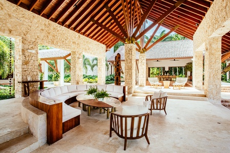 Spacious outdoor seating area with wooden accents and garden view.