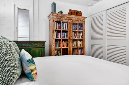 Curl up with your favorite book in this charming bedroom featuring a rustic wooden bookcase filled with literary treasures.
