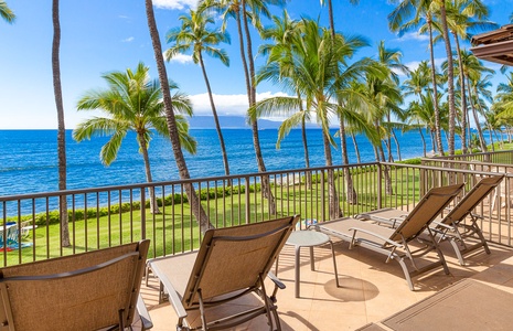 Relax on the private lanai with breathtaking oceanfront views and swaying palm trees.