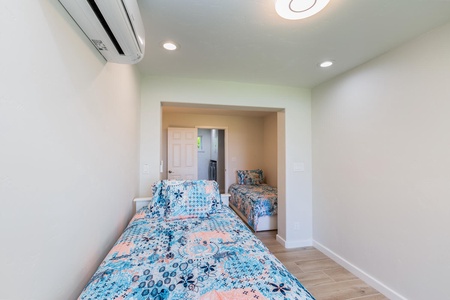 Guest Room 3 -  two twin beds and bright, colorful bedding.