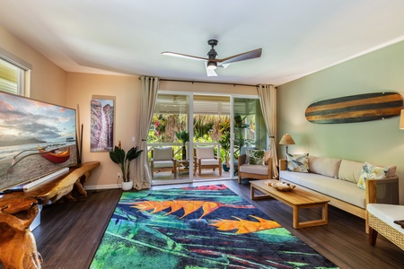 The spacious living room opens to the lanai, bringing the outdoors in.