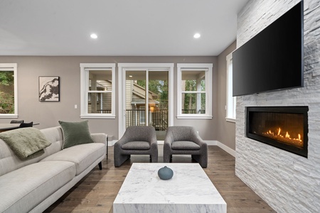 Elegant living space where modern comfort meets warm ambiance. The flickering fireplace and plush seating create perfect moments for relaxation.