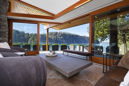 Elegant seating area with modern furnishings and a seamless water view.