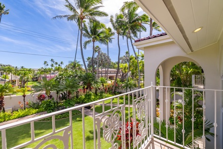 Private lanai with views of lush gardens and palm trees, offering a perfect spot to enjoy the tropical scenery.